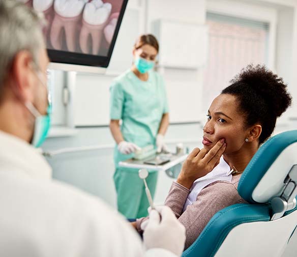 Patient and dentist discussing the cost of dental emergencies in Flint