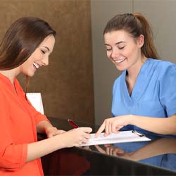 Dental employee explaining cost of treatment to patient