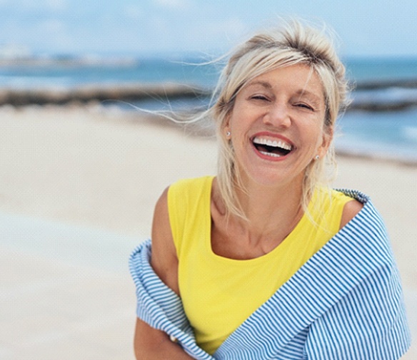 woman smiling knowing how to maintain her dental implants in Flint