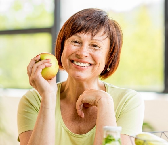 Smiling woman holding an apple