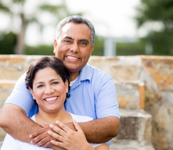 Man and woman smiling outdoors