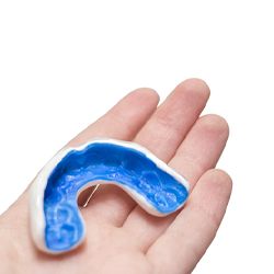 Person holding a custom mouthguard