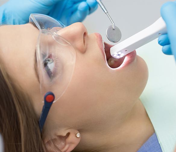 Dentist using intraoral camera to capture images