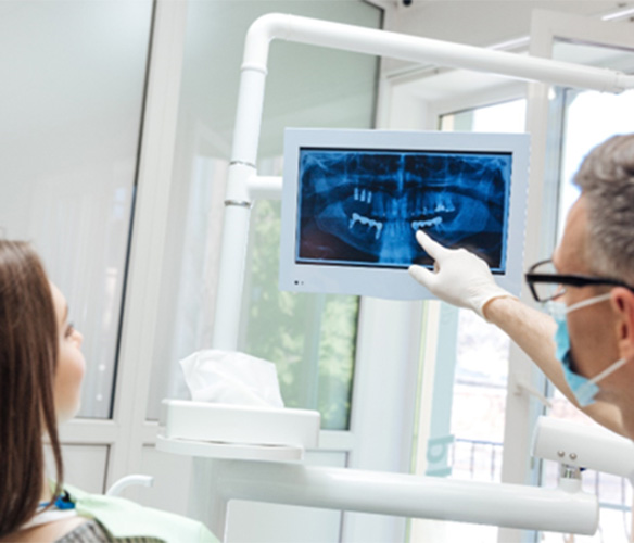 Flint, TX dentist looking at X-ray w/ patient